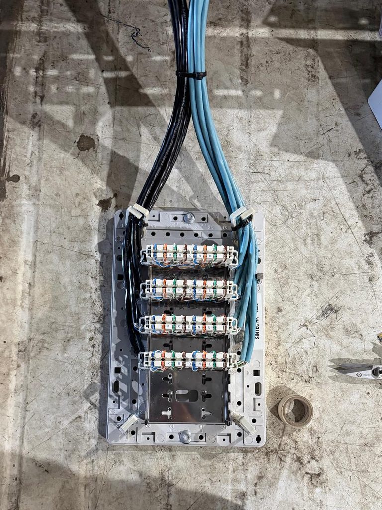 Krone IDC modules punched down and colour-coded on a frame ready for mounting
