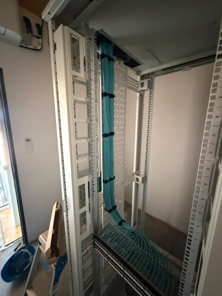Comms room cabinet build with the loom dressed in and copper panels populated
