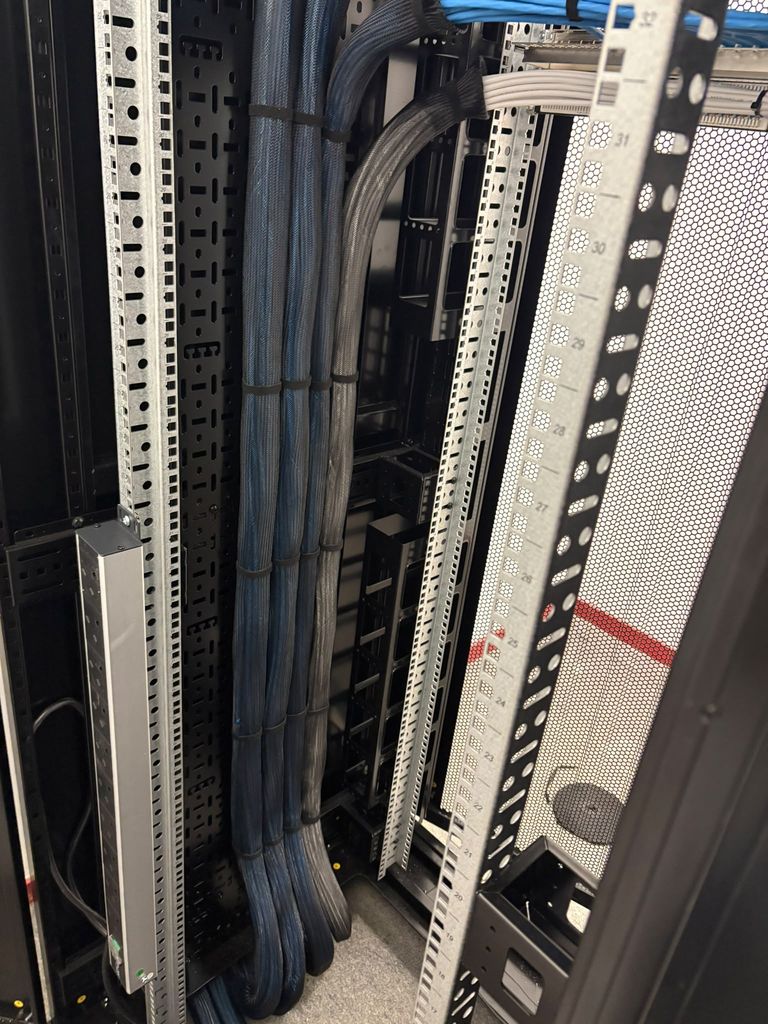 Braided sleeved looms dressed down the rear of a data cabinet